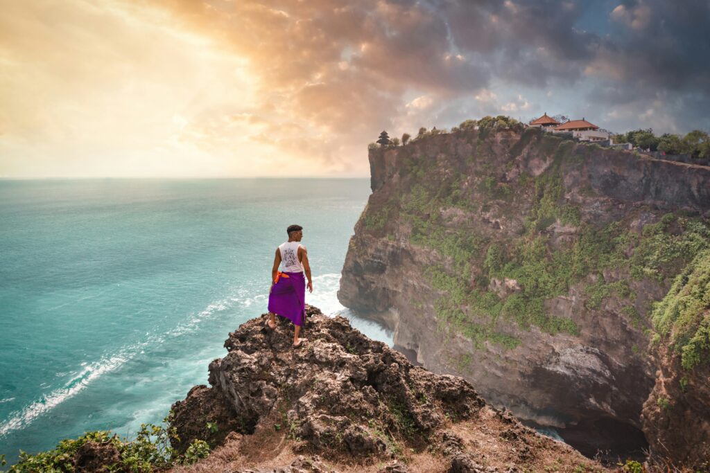guy standing on cliff in Uluwatu