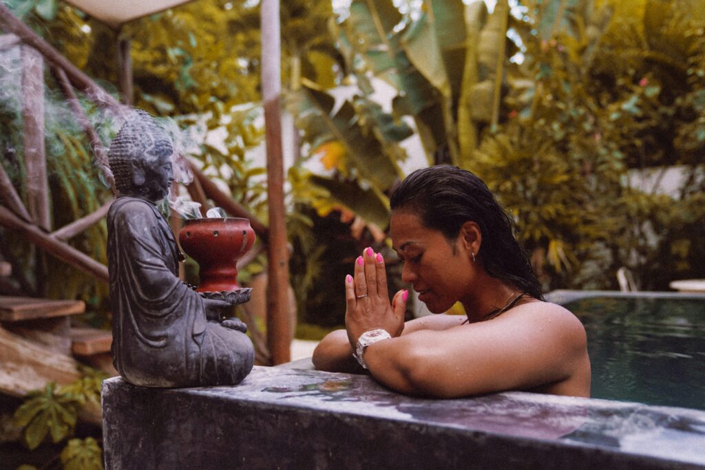 Woman praying at wellness spa