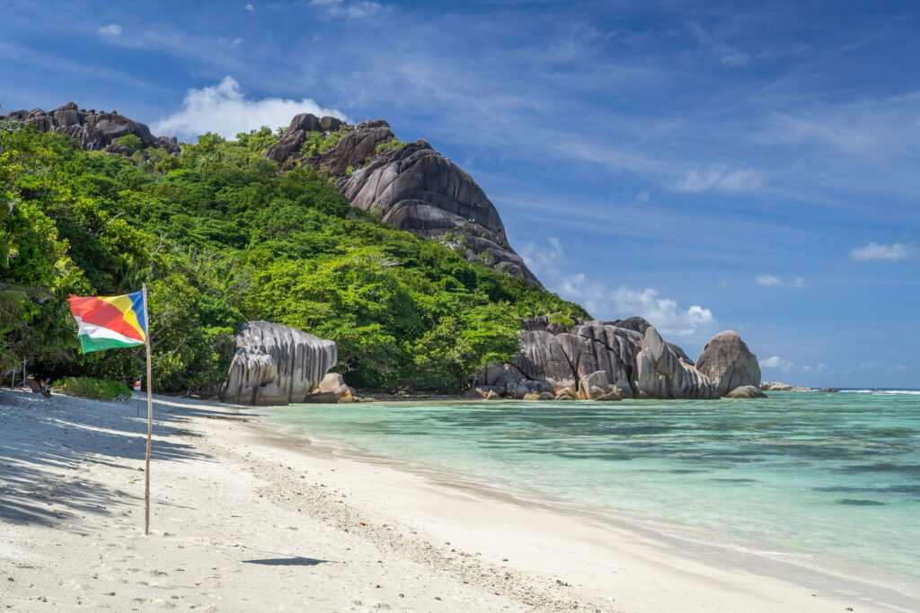 Seychelles flag in sand on beach