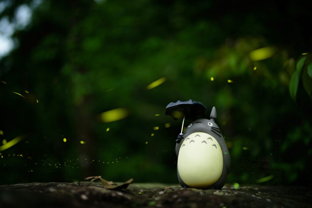 Totoro holding umbrella in rain