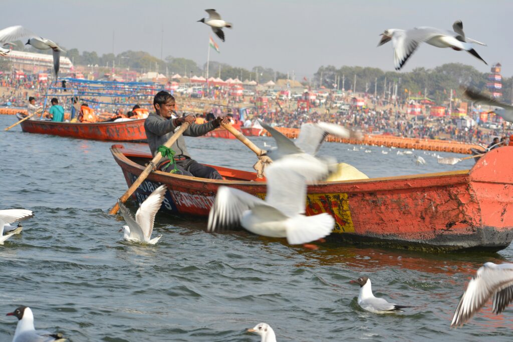 Kumbh Mela man rowing boat