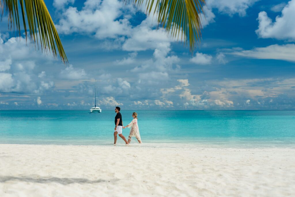 couple holding hands on Maldives beach