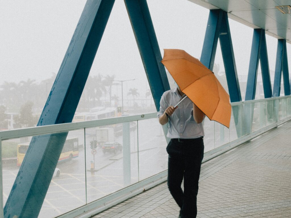 man with umbrella in Hong Kong rain
